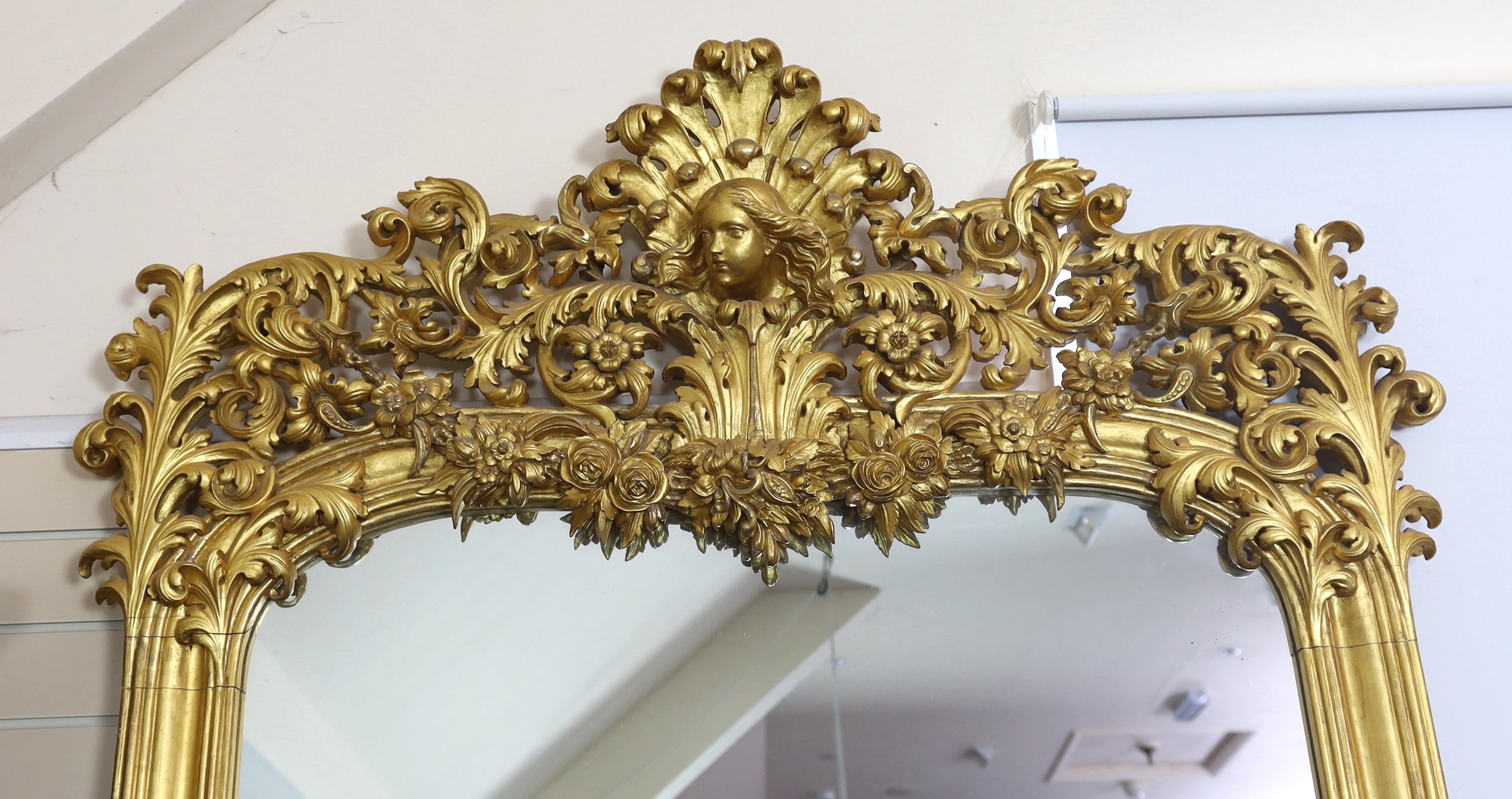 An ornate early 20th century carved giltwood wall mirror, width 146cm, height 250cm